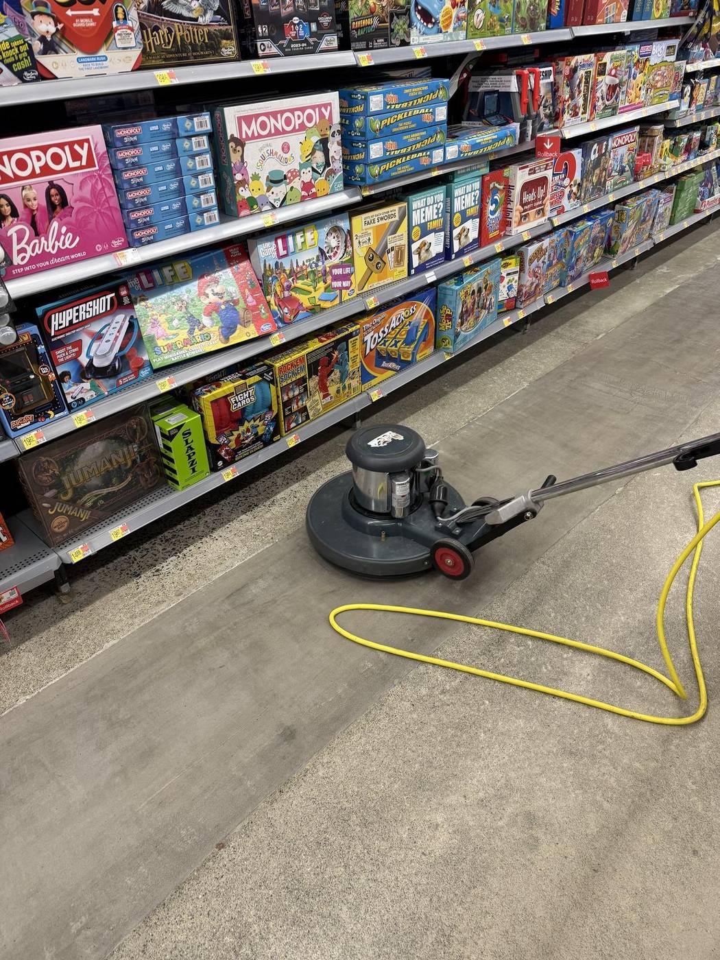 Floor machine cleaning a retail aisle overnight