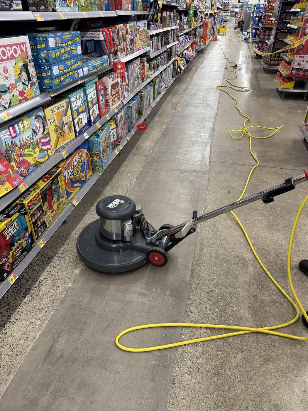 Floor machine working a retail floor