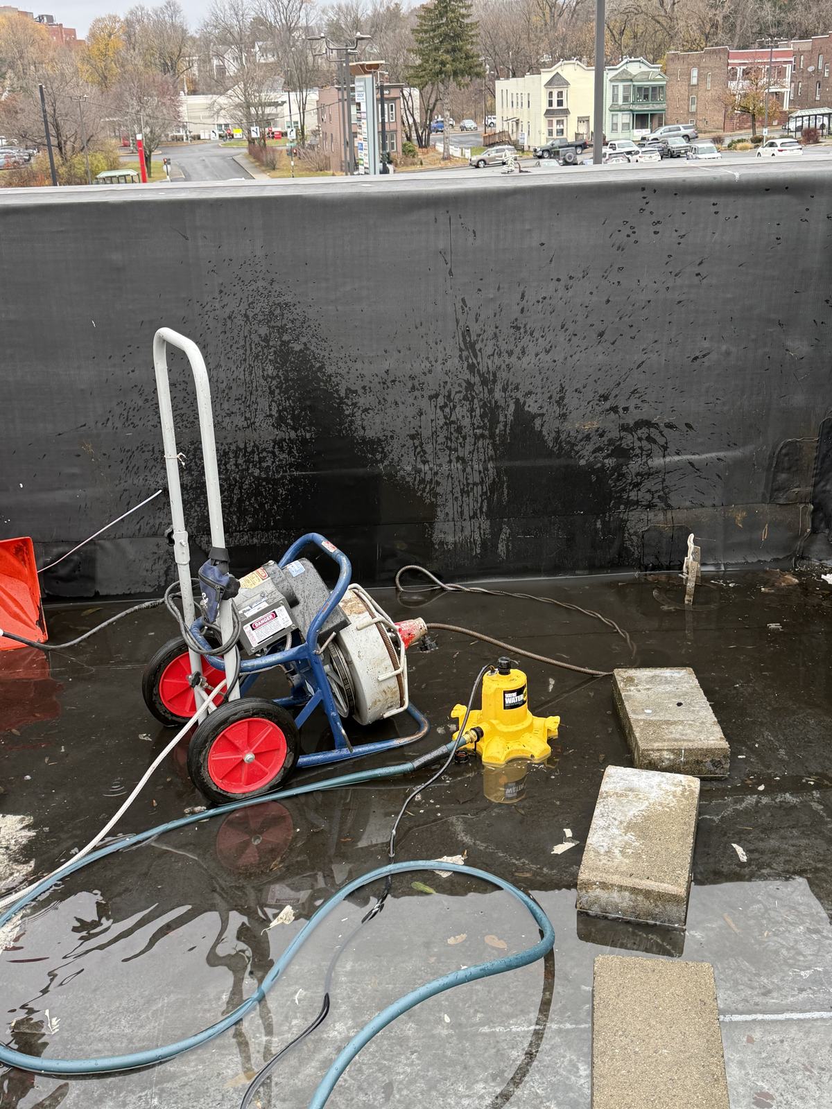 Rooftop pressure washing equipment on a commercial roof